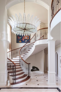 The foyer is lavished with a 1940s Italian chandelier fashioned of glass feathers. A 300-pound jade tiger on a custom Lucite base stands guard at the base of the stairs.
